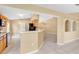 Open kitchen view with stainless steel appliances, breakfast bar, and tile flooring seamlessly connecting to living spaces at 3001 Bellingham Dr, Orlando, FL 32825