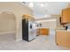 Well-equipped kitchen featuring modern appliances, ample cabinetry, and smooth tile flooring for easy maintenance at 3001 Bellingham Dr, Orlando, FL 32825