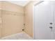 A small laundry room with basic shelving, tile flooring, and a utility door at 3001 Bellingham Dr, Orlando, FL 32825