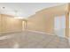 Bright living room with neutral walls, tile floors, and an open layout, perfect for entertaining and relaxation at 3001 Bellingham Dr, Orlando, FL 32825