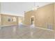 Spacious living area with tile flooring, neutral decor, and arched openings that provide an inviting flow throughout the home at 3001 Bellingham Dr, Orlando, FL 32825
