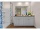 Clean bathroom with a double sink vanity and walk-in shower, enhanced by natural lighting and decorative accents at 3178 Partington Blvd, Davenport, FL 33837
