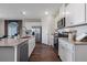 Modern kitchen featuring stainless steel appliances, a central island with seating, and plenty of storage space at 3178 Partington Blvd, Davenport, FL 33837