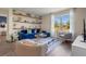 Comfortable living room boasting a large window, elegant furnishings, and open shelving at 3178 Partington Blvd, Davenport, FL 33837