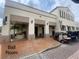 Ball room entrance with golf carts parked in front and palm trees in pots at 321 Davinci Pass, Kissimmee, FL 34759
