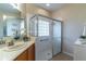 Bathroom featuring wood cabinets, tile flooring, and glass enclosed shower at 321 Davinci Pass, Kissimmee, FL 34759