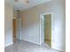 A spacious bedroom with neutral walls, tile flooring, and a walk-in closet at 321 Davinci Pass, Kissimmee, FL 34759