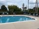 Inviting community pool with clear water and lounge chairs under an open sky at 321 Davinci Pass, Kissimmee, FL 34759