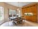 Dining area with a table, bench, and built-in wooden cabinets at 321 Davinci Pass, Kissimmee, FL 34759