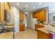 An additional view of the kitchen featuring wood cabinets and neutral countertops at 321 Davinci Pass, Kissimmee, FL 34759