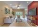 Bright living room features tile floors, a ceiling fan, and patio access at 321 Davinci Pass, Kissimmee, FL 34759