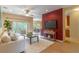Comfortable living room featuring a ceiling fan, tile floors, and sliding glass doors to the patio at 321 Davinci Pass, Kissimmee, FL 34759