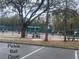 Outdoor pickle ball court with players and surrounding green space at 321 Davinci Pass, Kissimmee, FL 34759