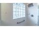 Shower with glass block window, stainless hardware, and white tiled walls at 321 Davinci Pass, Kissimmee, FL 34759