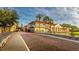 Beautiful street view showcasing the building's architecture, palm trees, and inviting atmosphere at 321 Davinci Pass, Kissimmee, FL 34759