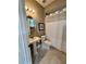 Cozy bathroom with pedestal sink, oval mirror, and tiled floors at 3840 Stone Pine Ct, Oviedo, FL 32766