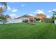 Spacious backyard with lush green lawn and white fence at 3930 Hydrangea Ct, Oviedo, FL 32766