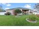 Large backyard with lush grass, established trees and landscaped garden at 3930 Hydrangea Ct, Oviedo, FL 32766