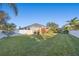 Well-manicured backyard with a lush green lawn, privacy fence and mature trees offering ample shade at 3930 Hydrangea Ct, Oviedo, FL 32766