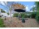 Backyard featuring garden, stone patio, seating and shade umbrella at 3930 Hydrangea Ct, Oviedo, FL 32766