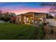 Spacious backyard featuring a lush lawn and covered patio with outdoor seating at 3930 Hydrangea Ct, Oviedo, FL 32766
