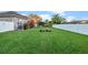 Expansive backyard boasts well-maintained lawn, privacy fence, and neat landscaping at 3930 Hydrangea Ct, Oviedo, FL 32766