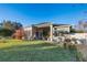 Lush backyard with a well-maintained lawn, patio area with outdoor seating and mature trees at 3930 Hydrangea Ct, Oviedo, FL 32766