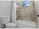 Full bathroom featuring shower-tub combo, tiled wall accents, and white fixtures at 3930 Hydrangea Ct, Oviedo, FL 32766