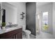 Modern bathroom with a marble countertop, stylish vanity, and walk-in shower at 3930 Hydrangea Ct, Oviedo, FL 32766