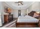 Bright bedroom featuring dark wood furniture, a TV, and tray ceiling at 3930 Hydrangea Ct, Oviedo, FL 32766