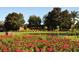 Community entrance with colorful flowerbeds and landscaping, showcasing the neighborhood's name, The Sanctuary at 3930 Hydrangea Ct, Oviedo, FL 32766