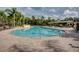 Spacious community pool featuring lounge chairs, tables, umbrellas and a beautiful sun deck at 3930 Hydrangea Ct, Oviedo, FL 32766