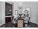 Elegant dining room with a chandelier, dark wood table, and stylish décor at 3930 Hydrangea Ct, Oviedo, FL 32766