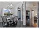 Sophisticated dining area with a chandelier, large windows, and sleek tile flooring creating an inviting atmosphere at 3930 Hydrangea Ct, Oviedo, FL 32766