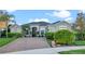Inviting single-Gathering home featuring a brick driveway and neatly manicured shrubs and manicured lawn at 3930 Hydrangea Ct, Oviedo, FL 32766