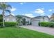Attractive single story home boasting lush front yard and beautiful tropical landscaping and stone accents at 3930 Hydrangea Ct, Oviedo, FL 32766