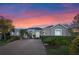 Beautiful single-story home featuring a large brick driveway, arched entry, and meticulous landscaping at 3930 Hydrangea Ct, Oviedo, FL 32766