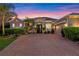 Beautiful single-story home featuring a large brick driveway and meticulously manicured landscaping at 3930 Hydrangea Ct, Oviedo, FL 32766