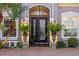 Elegant arched doorway featuring wrought iron doors and lush landscaping accents at 3930 Hydrangea Ct, Oviedo, FL 32766
