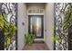Close-up of the front door with decorative ironwork and tiled entryway at 3930 Hydrangea Ct, Oviedo, FL 32766