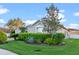 Well-maintained home featuring lush lawn, manicured shrubs, and mature trees, creating an inviting landscape at 3930 Hydrangea Ct, Oviedo, FL 32766