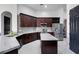 This kitchen features stainless steel appliances, white countertops, dark cabinets, and a center island at 3930 Hydrangea Ct, Oviedo, FL 32766