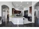 An open concept kitchen design with a large counter, stainless steel appliances, and dark cabinets at 3930 Hydrangea Ct, Oviedo, FL 32766