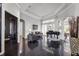 Expansive living room featuring a grand piano, high ceilings, and dark tile flooring at 3930 Hydrangea Ct, Oviedo, FL 32766