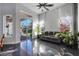Bright living room featuring sliding glass doors, dark floors, and ample natural light at 3930 Hydrangea Ct, Oviedo, FL 32766