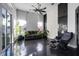 Bright living room featuring dark floors, white walls, and large windows for ample natural light at 3930 Hydrangea Ct, Oviedo, FL 32766