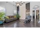 Stylish living area with modern furniture, glossy floors, and a decorative accent wall with abundant natural light at 3930 Hydrangea Ct, Oviedo, FL 32766
