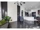 Modern living room featuring dark floors, white stone wall feature, and open floor plan at 3930 Hydrangea Ct, Oviedo, FL 32766