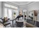 Elegant living room with a grand piano, lots of natural light, and sleek flooring at 3930 Hydrangea Ct, Oviedo, FL 32766