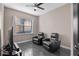 Cozy living room with two leather recliners, sleek television, and abundant natural light at 3930 Hydrangea Ct, Oviedo, FL 32766